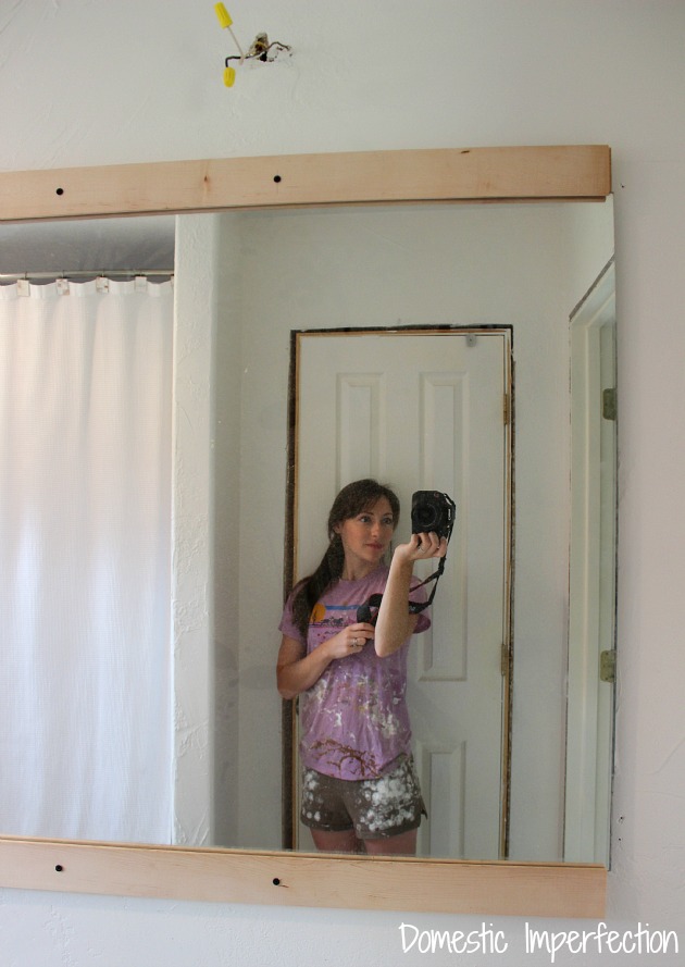 Hanging a mirror with wood flooring