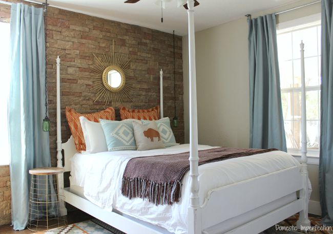 bedroom with rock feature wall