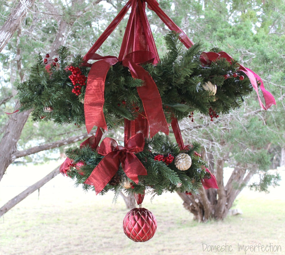 How to make a chandelier to of wreaths, ribbon, and ornaments. So simple and pretty!