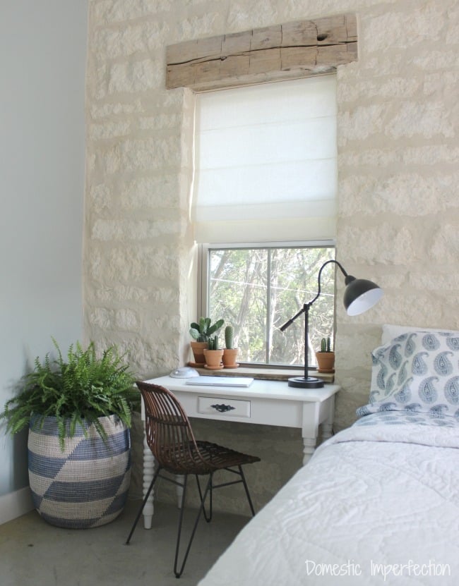 linen shades and limestone wall