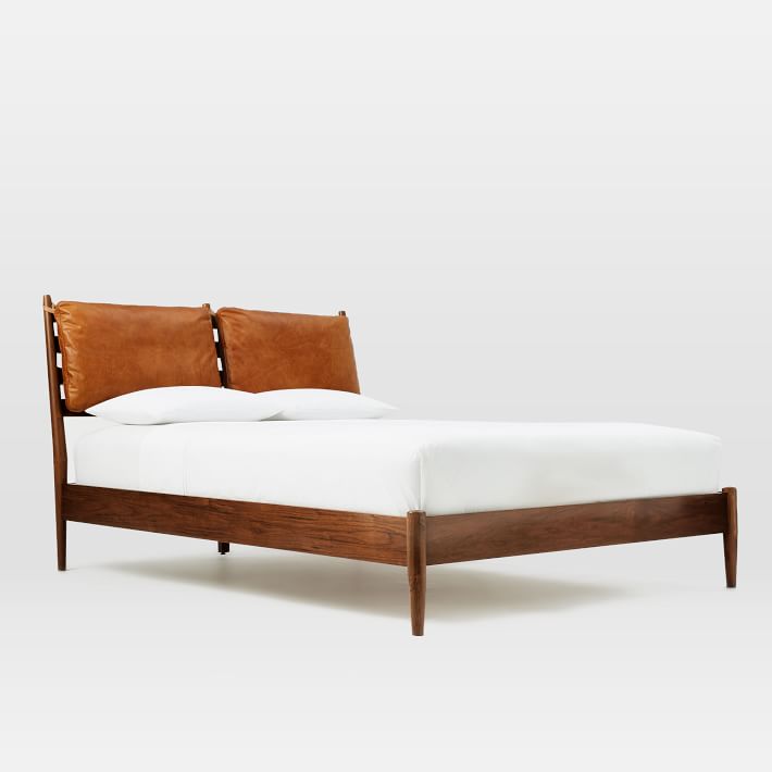 wooden bed with leather cushions
