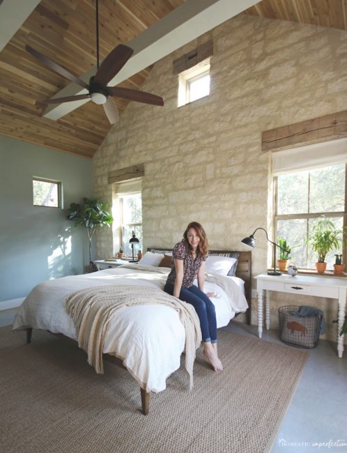 rustic master bedroom wood ceiling limestone wall 