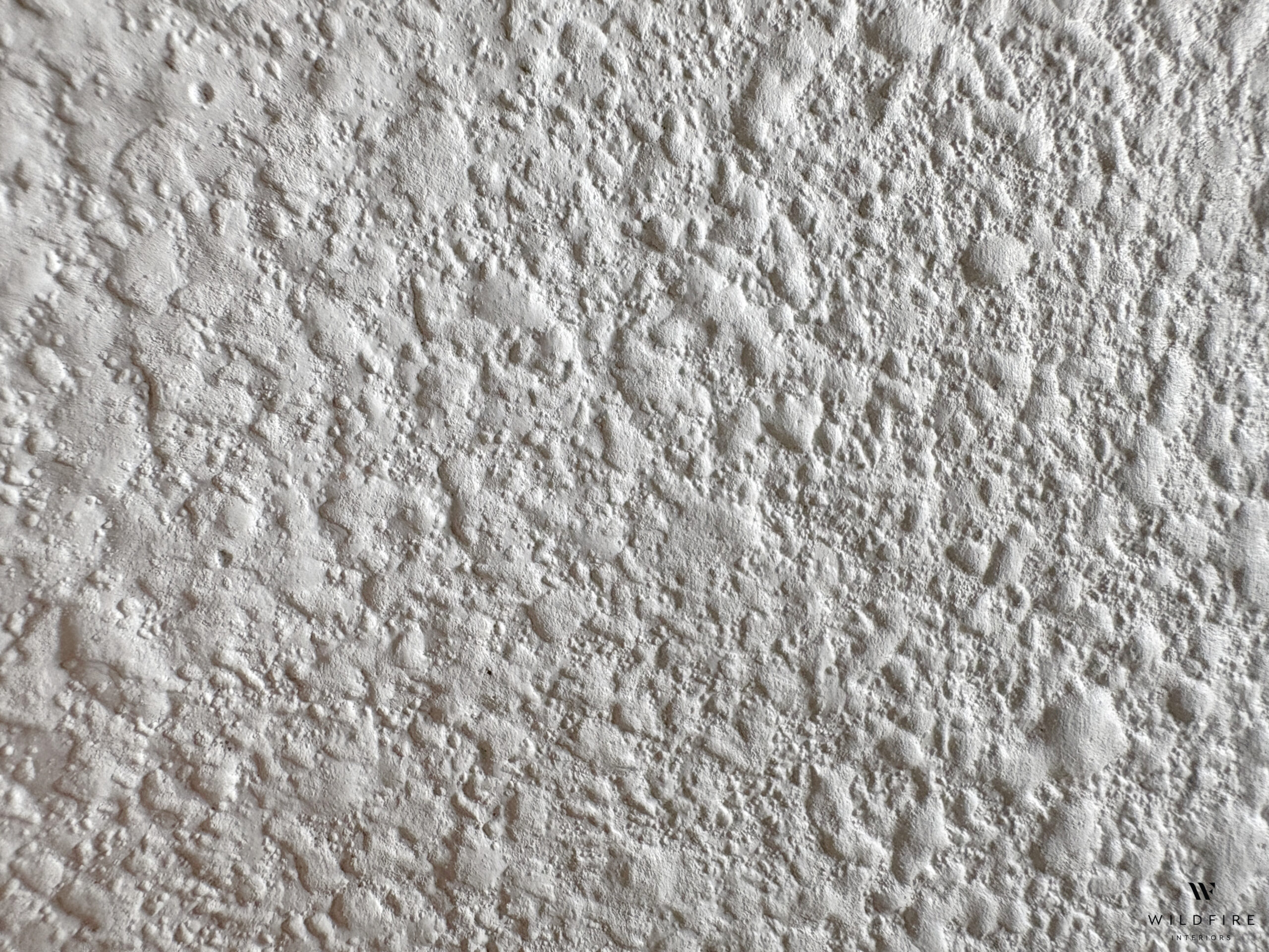Orange peel textured walls - will adhesive wallpaper stick to it? 