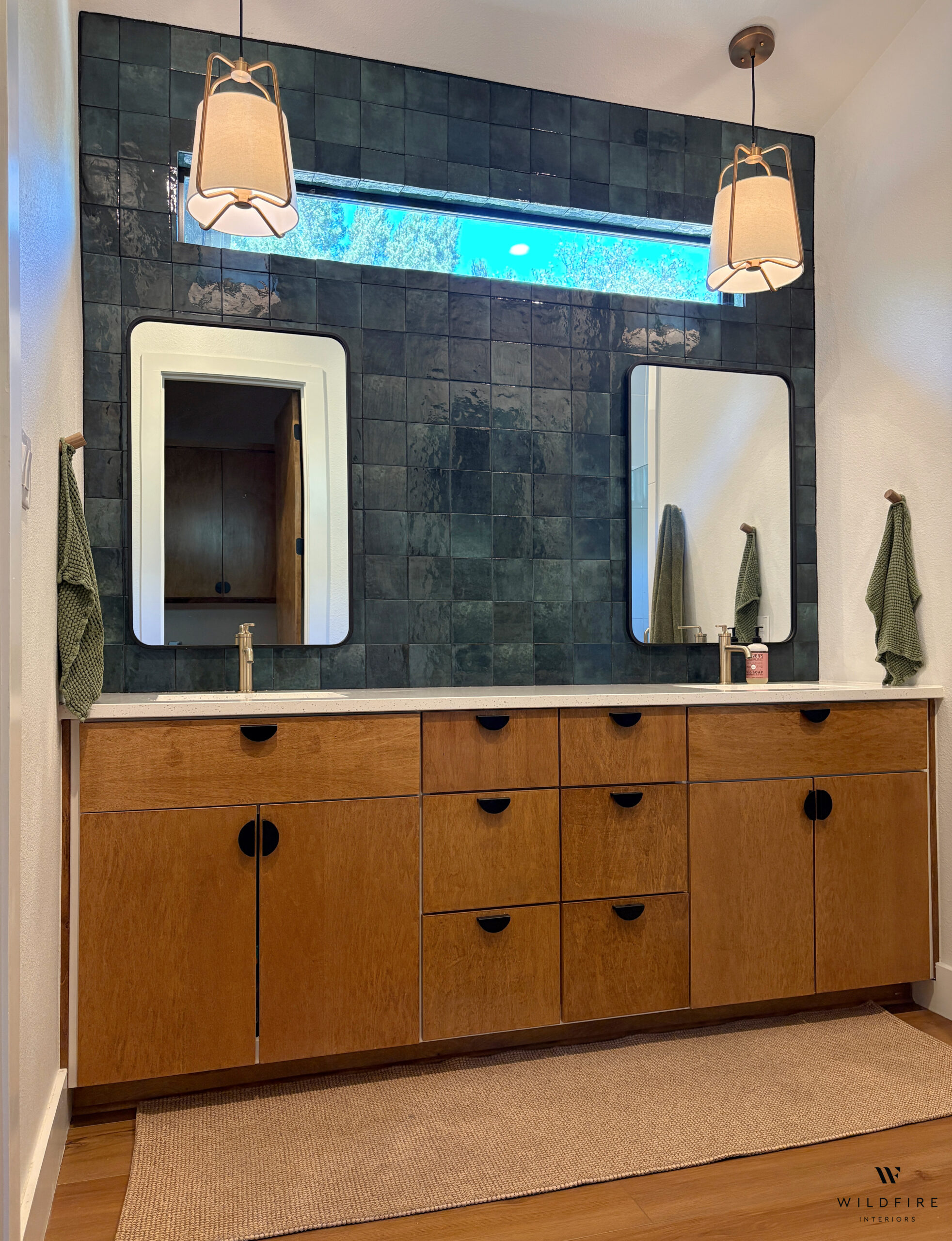 Mid-century style bathroom with wooden cabinets and dark green tile.