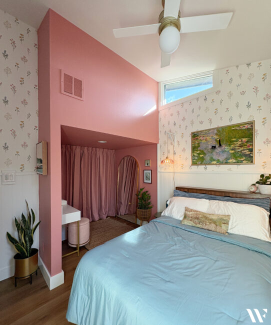 Teenage girls bedroom makeover with floral wallpaper, pink walls, white paneling and feminine decor.