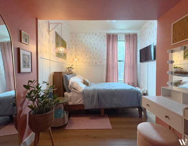 Feminine teenage girl's bedroom with pink and blue accents, floral wallpaper and added clothing storage.