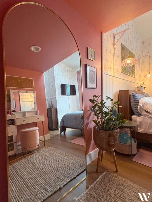 Teenage girl's bedroom transformed into a light, feminine space with floral wallpaper, soft colors and hidden closet storage.